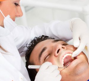 A dentist examining a patient.