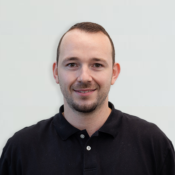 A photo of a man smiling.